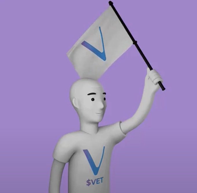 A white 3D character holds a flag and displays a blue checkmark logo with the text '$VET' on its chest against a purple background.
