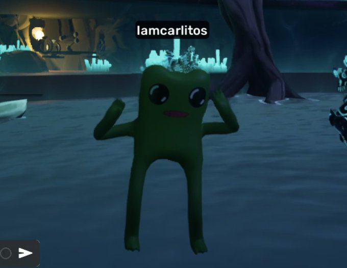 A green cartoonish "Fwog" character with large eyes stands in a dark, fantasy-themed virtual environment with crystalline structures in the background, labeled with the username "Iamcarlitos" above it. The character appears excited with arms raised, fitting the post's reference to loving the party on the OthersideMeta platform.