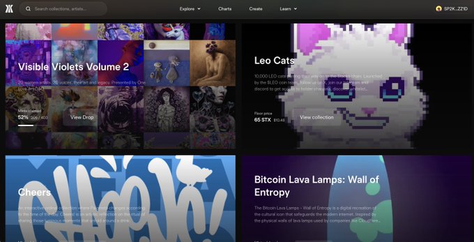 The image shows a homepage featuring four NFT collection cards, including one prominently displaying "Leo Cats" with a floor price of 65 STX (15,485). The post celebrates this Leo Cats collection being featured on the homepage alongside others like "Visible Violets Volume 2" and "Bitcoin Lava Lamps: Wall of Entropy."