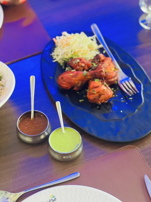 The image shows a dining table with various dishes, including a plate of food containing chicken wings and a bowl of sauce. The table also has utensils such as forks and knives placed around it. The focus of the image is on the food items and their arrangement, rather than any additional context or information about the post that includes the phrase "Everyone wants onchain finance to scale. But scaling isn'