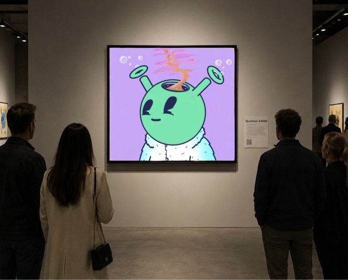 A group of gallery-goers stand viewing a large digital artwork of a green, alien-like character with antennae against a lavender background, displayed alongside an informational placard reading "Quirkies #4060." The scene captures the moment of appreciating this NFT fine art piece by Quirkies.