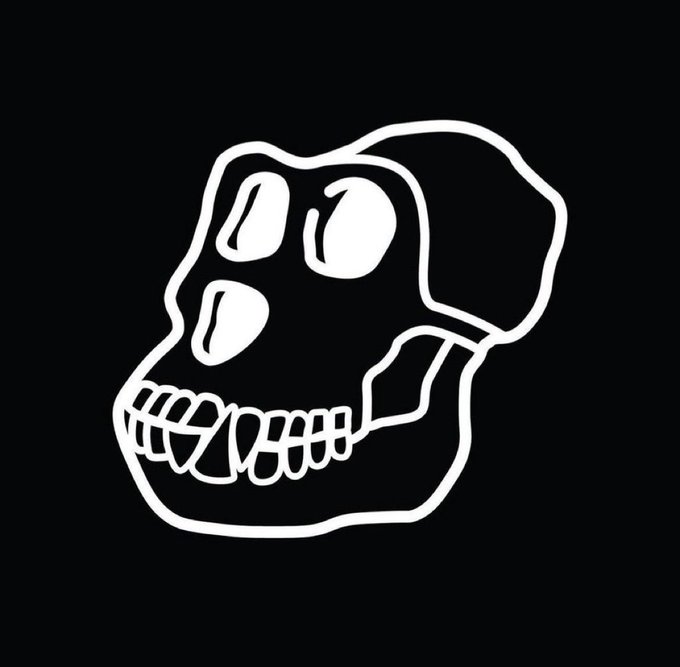A black background displaying a simple white line drawing of a stylized monkey or ape skull face with bared teeth.