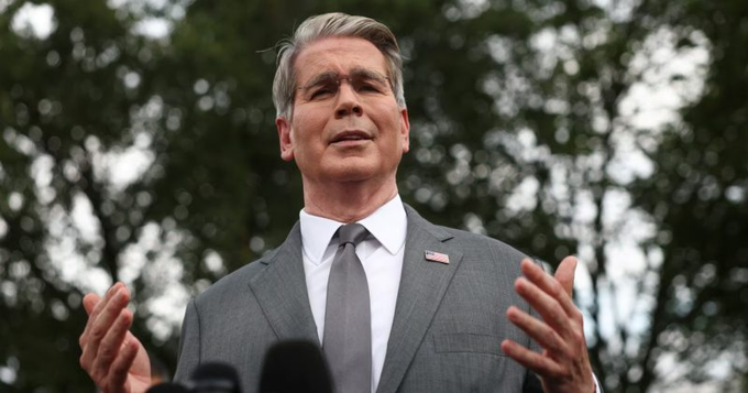 Secretary of the Treasury Scott Bessent speaks outdoors in a gray suit with an American flag pin, gesturing while addressing reporters.

The image relates to the post by showing Secretary Bessent, who oversees the U.S. Treasury—the department managing the $935 billion TGA cash balance mentioned as a potential catalyst for risk assets, including crypto.