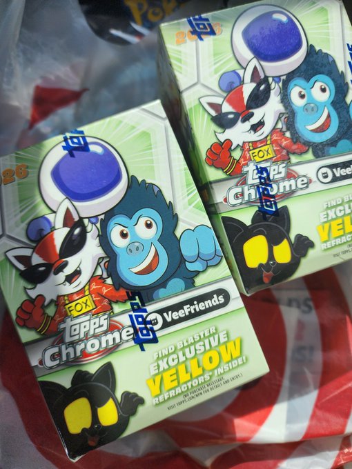 Two "Topps Chrome" VeeFriends booster boxes featuring characters like Fox and a blue gorilla are shown, advertising an "Exclusive Yellow Refractor + Inside!" promo while sitting on a red and white plastic Target bag.