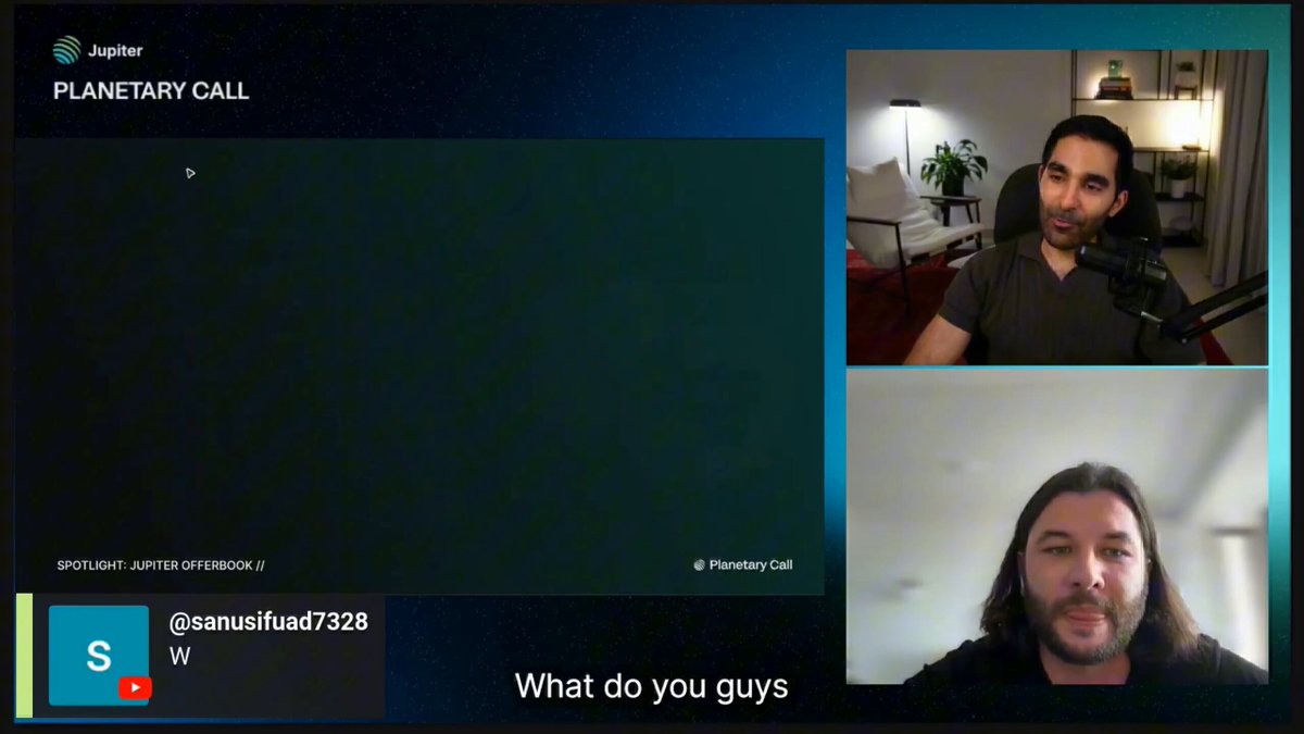 The image shows two men sitting across from each other, having a video call using a computer screen displaying their faces. The man on the left side of the frame has long hair and is wearing a black shirt, while the man on the right side has short hair and is dressed in a gray shirt. They appear to be engaged in conversation or discussing something important.

The image also contains text that reads "Focus on what is in the image and how it relates to the post @jup_offerbook". This suggests that there might be some connection between the two men's appearance, their video call, and a recent post made by someone named @JupiterExchange Planetary Call.