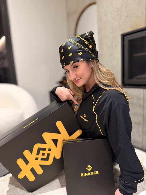 This image showcases a promotional event where the person is proudly presenting a gift box branded with the BINANCE logo and a Bitcoin theme. The accompanying post expresses gratitude to the person being celebrated, suggests a long-term future, and acknowledges Binance's digital square platform.