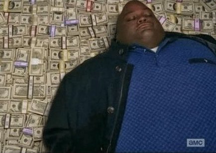 A man lying on a bed covered entirely with dollar bills, a popular 'getting paid' meme image with an AMC watermark.