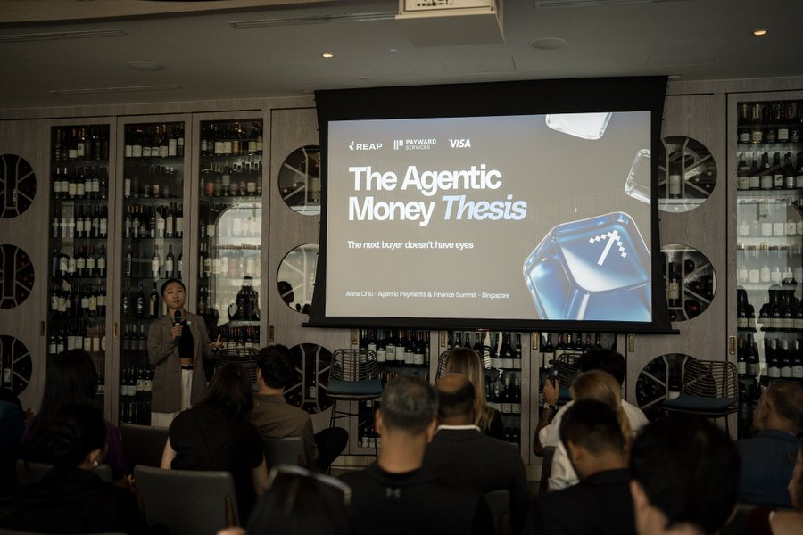 A speaker presents at the 'Agentic Payments & Finance Summit - Singapore,' with a slide titled 'The Agentic Money Thesis' subtitled 'The next buyer doesn't have eyes,' displayed on a screen beside wine cabinets.