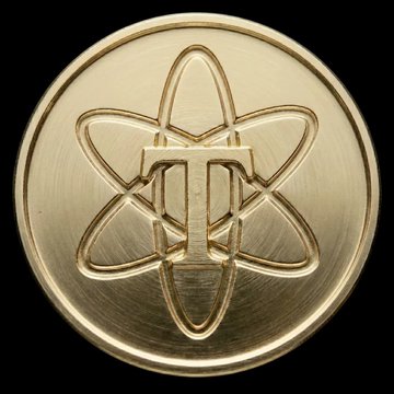 A gold coin featuring an atomic-style design with the letter "T" at its center, set against a black background. The image visually represents "Torium," one of the mobile mining projects highlighted in the post, symbolizing its atomic/molecular branding.