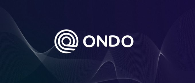 The image features the Ondo logo with its distinctive "@" emblem alongside the "ONDO" name in white, set against a dark blue background with flowing wave patterns. This branding visual complements the announcement of ONDO PERPS launching 24/7 perpetual futures for equities, ETFs, and commodities.