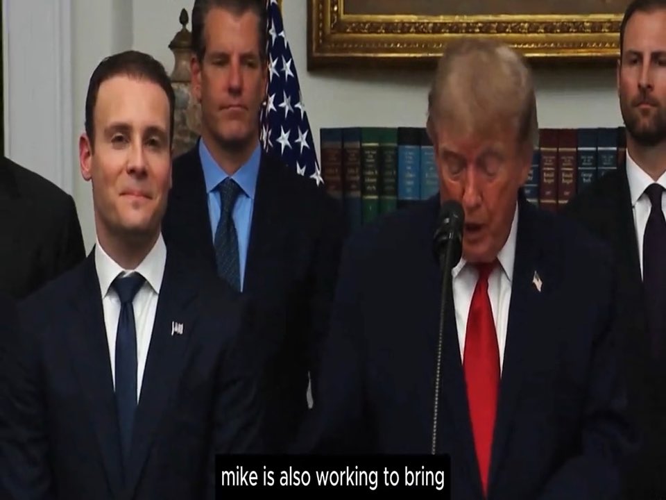 Donald Trump speaks at a podium with an American flag in the background, flanked by aides, as the subtitle reads "mike is also working to bring," referencing his comments about the CFTC working to bring Hyperliquid into the U.S.