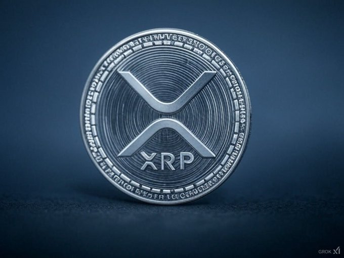 A close-up of a silver XRP cryptocurrency coin featuring the distinctive 'X' logo, displayed against a dark blue background.