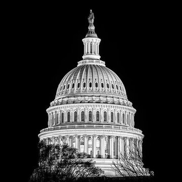 The iconic dome of the U.S. Capitol building is illuminated against a dark sky, symbolizing the political arena where the CLARITY Act is being discussed. This visual reinforces the post's message about the ongoing push for clear digital asset rules in the United States.