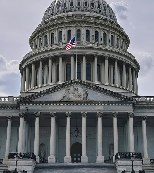 The image shows the US Capitol Building with its iconic dome, columns, and American flag flying—symbolizing the legislative body at the center of the breaking news. The post notes the US House has canceled its September session, putting the CLARITY Act at risk as members leave by Sept. 17 with minimal time before midterm elections.