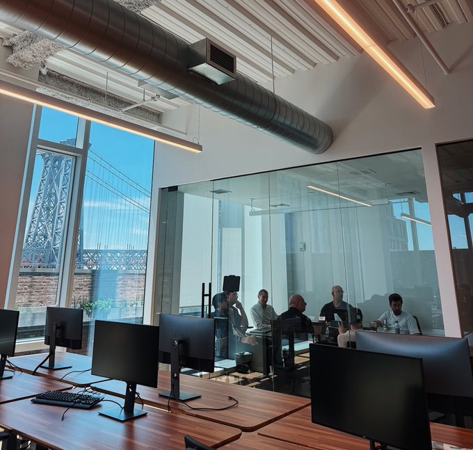 The image shows a group of people sitting around tables with computer monitors, likely working together or participating in an event. The room has large windows that provide natural light, creating a bright atmosphere. There are at least six people visible in the scene, some seated while others stand near their respective workstations. A few keyboards and mice can be seen on the tables as well.

The post features a photo of a group of men sitting around a table with computer monitors, suggesting that they might be working together or participating in an event related to cooking or food preparation. The image also includes a reference to the @centrifuge team, which could indicate that this gathering is taking place at their office or facility.