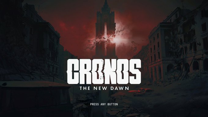 A video game title screen displaying the text "CRONOS - THE NEW DAWN" with "PRESS ANY BUTTON" beneath it, set against a post-apocalyptic backdrop of ruined buildings and a blood-red sky.