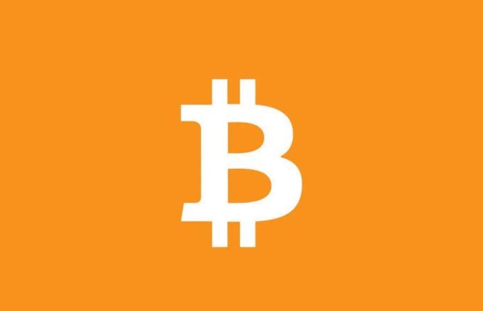 A white Bitcoin "₿" logo is centered on an orange background, symbolizing the cryptocurrency referenced in the post highlighting that Bitcoin's price was just $612 a decade ago compared to today's much higher valuation.