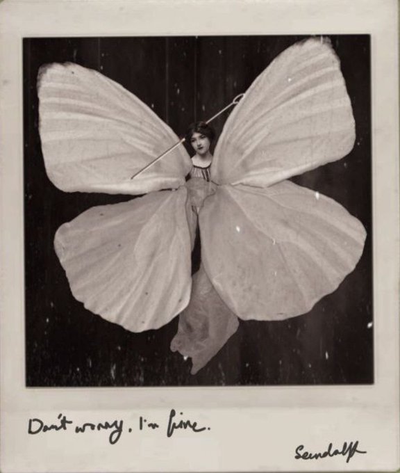 A vintage black-and-white polaroid-style photo of a woman dressed as a butterfly with large white wings, with the handwritten text 'Don't worry, I'm fine.' and 'Seundalff' at the bottom.