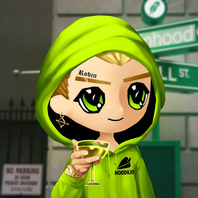 A chibi-style cartoon character wearing a green Hoodilio hoodie sips from a martini glass, featuring a "Robin" forehead tattoo and green eyes, positioned against a backdrop of blurred street signs. The "HOODILIO" branding on the hoodie ties directly to the post teasing a Robinhood-themed Hoodilio NFT collection reveal.