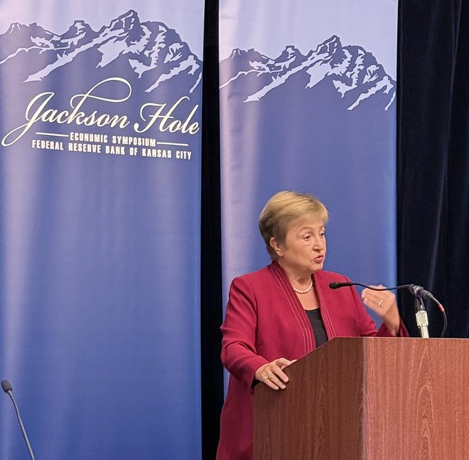 IMF Managing Director Kristalina Georgieva delivers a speech at the Jackson Hole Economic Symposium, with the event's banner displayed behind her, addressing how stablecoins could drive demand for U.S. debt.