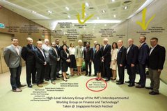 A group photo of delegates from the High Level Advisory Group of the IMF's Interdepartmental Working Group on Finance and Technology, including representatives from the Federal Reserve Bank of New York and Singapore Fintech Festival, taken at the Singapore Fintech Festival, with Brad Garlinghouse noted among attendees, visually representing the IMF collaboration being referenced as potentially influencing XRP's role as a cross-border settlement model.