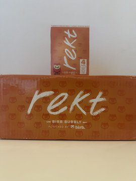 A package and small box of 'rekt' brand bird bubbly powered by birth., displayed with orange packaging featuring scattered branding.