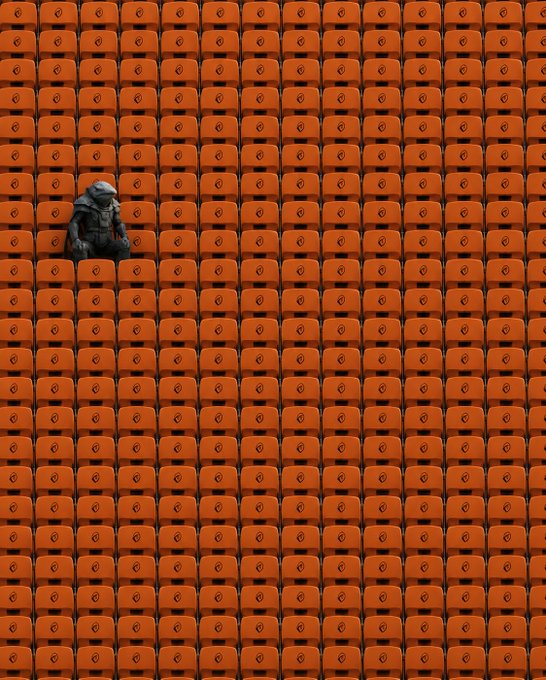 A small, hooded figure sits alone surrounded by a massive, repeating grid of identical orange plastic chairs.
