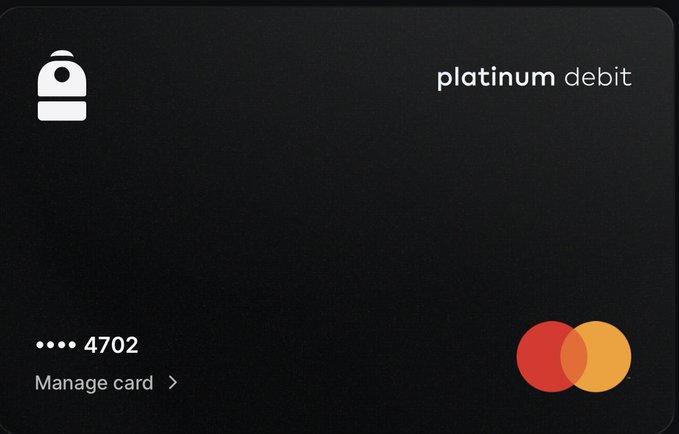 A minimalist black 'platinum debit' Mastercard ending in 4702, featuring a bell icon in the top left and a 'Manage card' option.