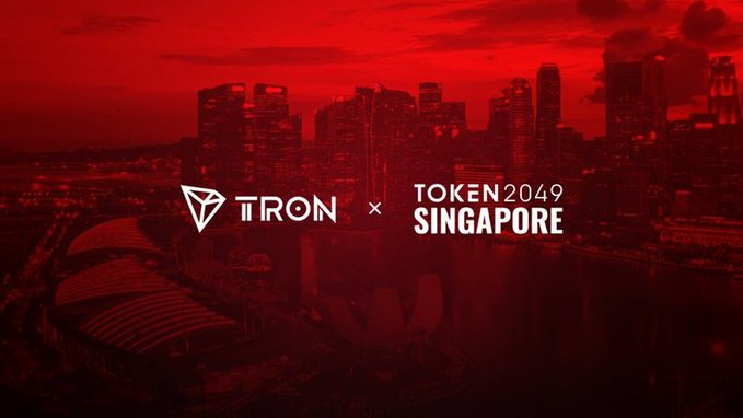 A promotional graphic with a red-tinted Singapore skyline background displays the logos and text 'TRON × TOKEN2049 SINGAPORE', advertising the conference event.