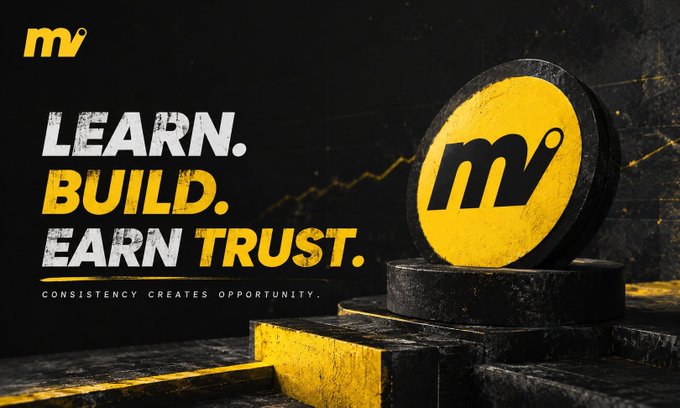 A promotional graphic with a yellow coin featuring the 'mv' logo on a black pedestal, alongside the text 'LEARN. BUILD. EARN TRUST. CONSISTENCY CREATES OPPORTUNITY.'