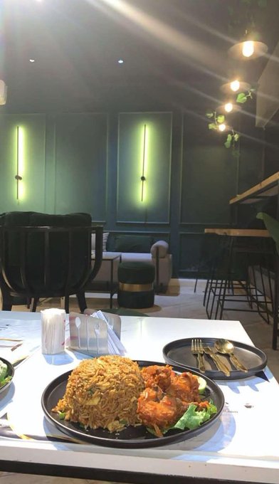 The image shows a dining table with two plates of food, including rice and meat, placed on top of it. The table also has various utensils such as forks, knives, and spoons arranged around the dishes. In addition to these items, there are chairs surrounding the table for seating. A potted plant can be seen in the background, adding a touch of greenery to the scene. The image is related to the post because it features an advertisement for Gn gTria's BestPath, which promotes the use of EVM and SVM chains in support of move-based ecosystems like Aptos.