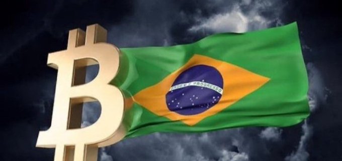 A golden Bitcoin symbol stands prominently in front of the Brazilian flag waving against a cloudy sky, visually representing Brazil's growing corporate adoption of Bitcoin, as exemplified by OranjeBTC's latest purchase of 30 BTC (bringing its total to 3,948 BTC).