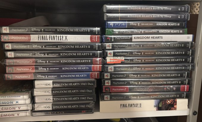 A shelf collection of PlayStation 2 video games, predominantly multiple copies of Kingdom Hearts titles along with Final Fantasy X and Final Fantasy XI.