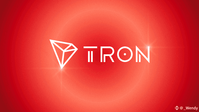 The image displays the TRON logo (a stylized white diamond/triangle icon next to the word "TRON") centered on a red gradient background, visually branding the post's discussion of TRON's record-breaking stablecoin transfer volume.