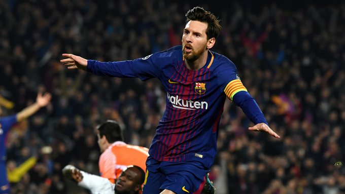 Soccer player Lionel Messi, wearing a Barcelona jersey with 'Rakuten' sponsor text, celebrates with arms outstretched during a match.
