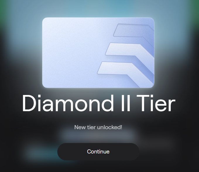 A digital tier upgrade notification displaying a silver card with a chevron logo, titled "Diamond II Tier" with text "New tier unlocked!" and a "Continue" button.