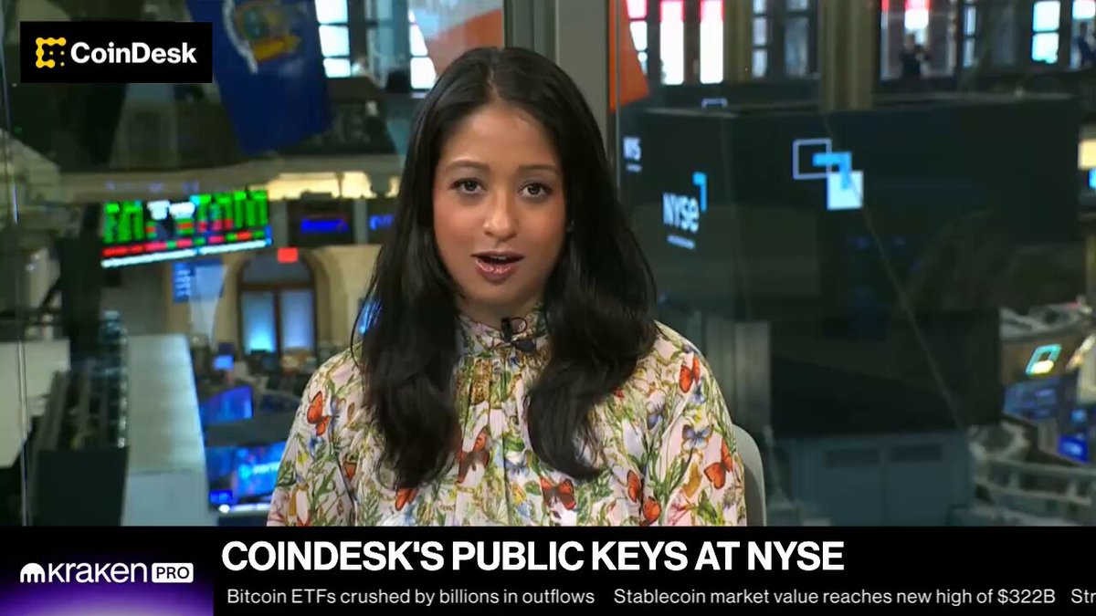 The image features a woman wearing a floral print shirt sitting at a desk with a computer screen behind her. The background of the image shows a news broadcast about cryptocurrency markets, specifically Bitcoin and Ethereum ETFs. The text on the image includes mentions of coinDesk's public keys at the @NYSE, @bitwise' @RasterlyRock's bull case for HYPE, @HypeStrat's @dschamis breakdown of leverage in crypto trading, and @Calamos 'Matt Kaufman on how".