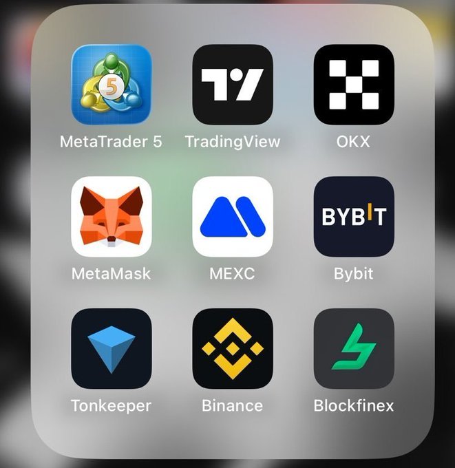 A smartphone home screen displays a folder of cryptocurrency and trading app icons, including MetaTrader 5, TradingView, OKX, MetaMask, MEXC, Bybit, Tonkeeper, Binance, and Blockfinex.