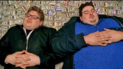 Two overweight men with glasses lie asleep on a couch against a patterned background.