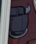 A small close-up image showing a cartoon depiction of a chair or piece of furniture in red and black tones.