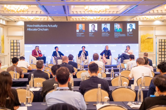 A panel discussion titled 'How Institutions Actually Allocate Onchain' takes place at a ZAMA conference, with speakers seated on stage before an audience.