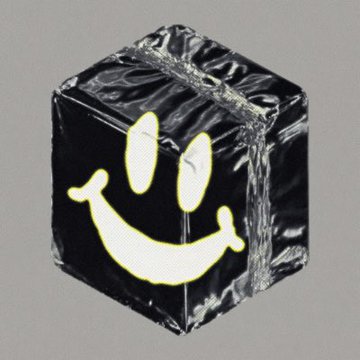 A black cube wrapped in plastic with a yellow smiley face design on it, displayed against a gray background.