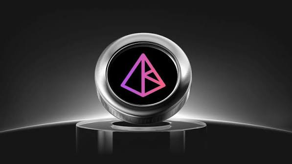 A 3D rendering of a metallic coin featuring a pink and purple triangular logo on a black background.