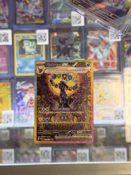 A holographic "Toedscruel" Pokémon trading card, number 224, is displayed prominently in the foreground, with additional cards visible in protective sleeves behind it, reflecting the poster's temptation to buy it for grading due to its pristine condition.