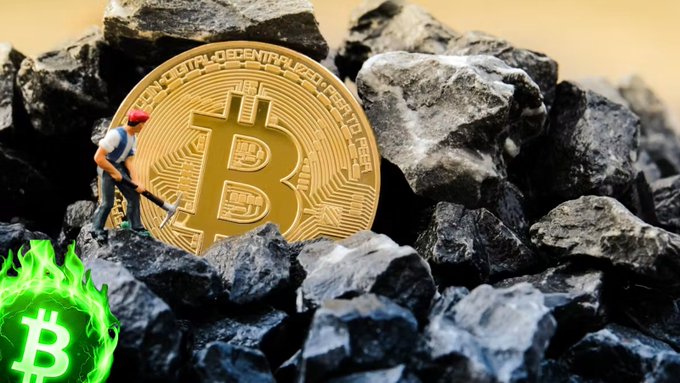 A miniature scene showing a tiny miner figure with a pickaxe standing on a pile of black coal rocks next to a large golden Bitcoin coin, with a green glowing Bitcoin logo with flames in the bottom left corner.