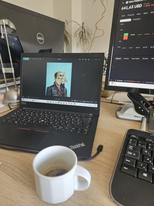 A ThinkPad laptop on a wooden desk displaying a portrait of a man, with a coffee mug, external Dell monitor showing a trading platform (641.63 USD), and a keyboard visible in the workspace.