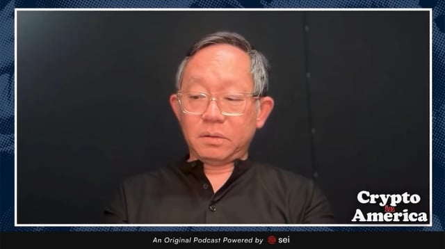 The image shows a man with gray hair and glasses wearing a dark shirt, appearing on a podcast or video segment. The image is branded with "Crypto America" and "An Original Podcast Powered by sei" at the bottom. This appears to be a visual associated with a discussion featuring the SUI co-founder speaking about how banks are resisting innovation in finance.