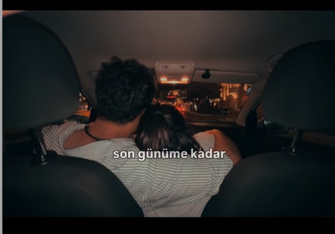 A couple sits in the backseat of a car at night, with the man resting his head on the woman's shoulder, accompanied by the Turkish text "son günüme kadar" (meaning "until my last day"). The intimate, tender scene complements the "Can I get a GM?" post by evoking a heartfelt good morning vibe of love and connection.