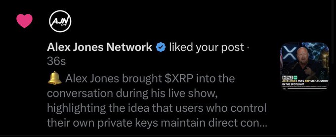 A social media notification shows that the verified Alex Jones Network liked the user's post, with a news clip thumbnail featuring Alex Jones and a headline about him discussing $XRP and private keys during his live show. The "Real recognize real" caption reflects the user's surprise and appreciation at being acknowledged by Alex Jones's platform, suggesting a sense of validation from a prominent figure in the crypto/conspiracy media space.