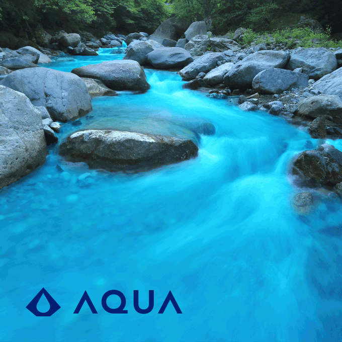 A turquoise stream flows smoothly over smooth boulders in a lush green forest, embodying Bruce Lee's philosophy of "be water" with its fluid, adaptive motion. The "AQUA" logo in the bottom corner ties the natural scene to a brand celebrating water's graceful, powerful essence.
